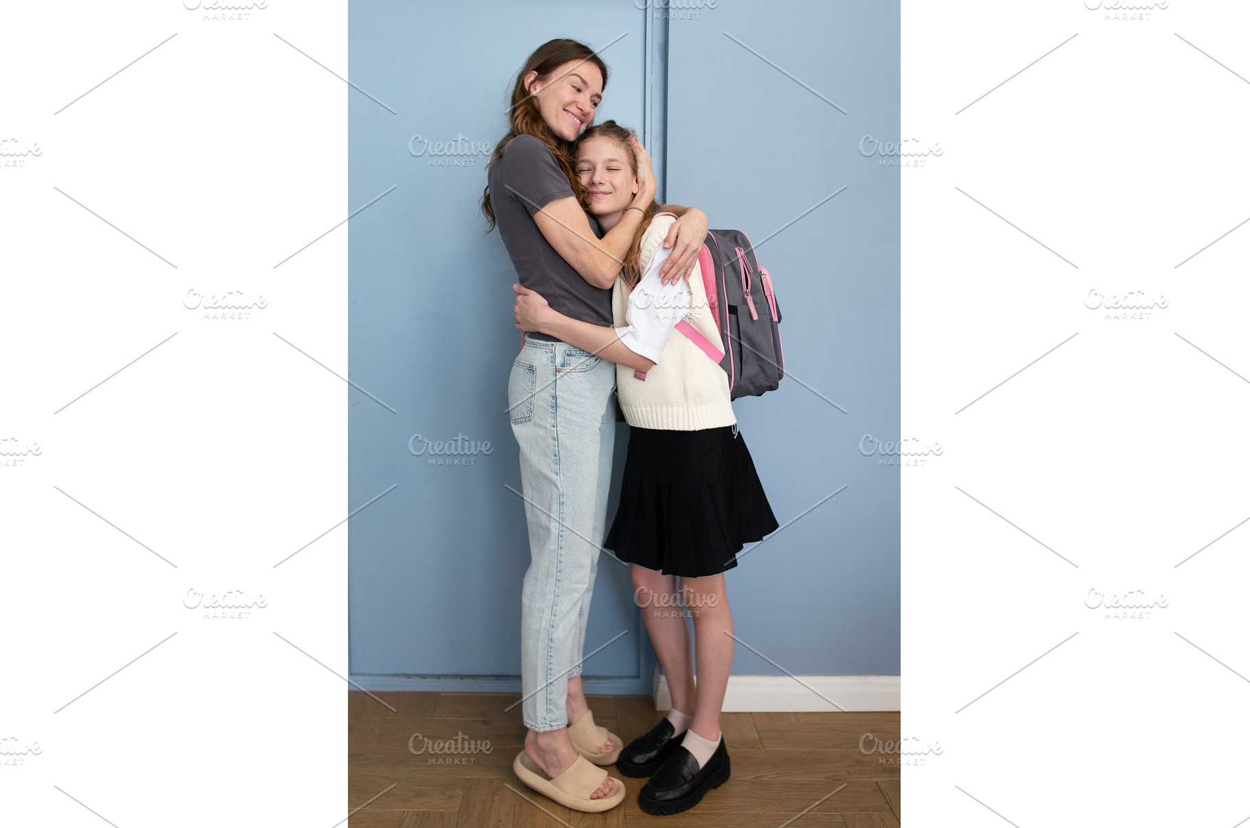 Mother hugs schoolgirl daughter at, a School & Education Photo by undrey