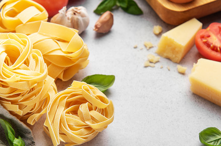 Fresh pasta, tomatoes, garlic, cheese, eggs and basil creating i, a Food & Drink Photo by Olena Rudo