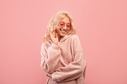 Pretty stylish lady looking down and smiling, wearing colorful sunglasses and h, a Photo by Prostock-Studio (Thumbnail 1 of 2)