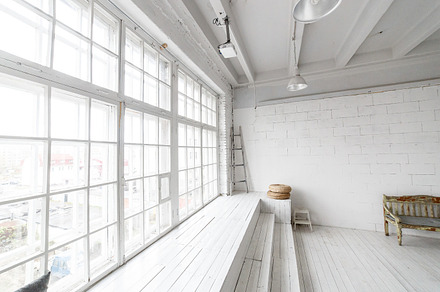 Bright photo studio interior with big window high ceiling white wooden floor, an Architecture Photo by Northern Life