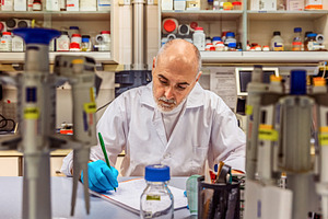 Scientist writing results in laborat, a Health & Medical Photo by Perpis