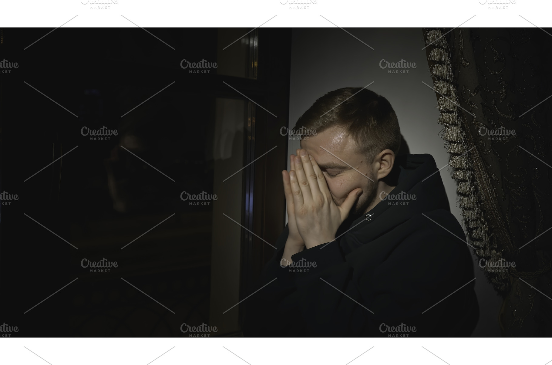 Young man sits tired and looks out, a Person Photo by Media Whale Stock
