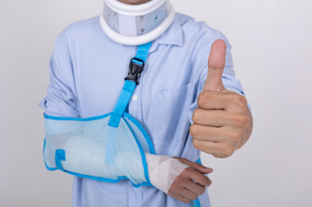 Asian man with broken arm and neck feeling showing thumbs up ges