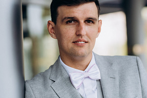 portrait of a groom in a suit and white bow, a Person Photo by Weddings, People, Travel