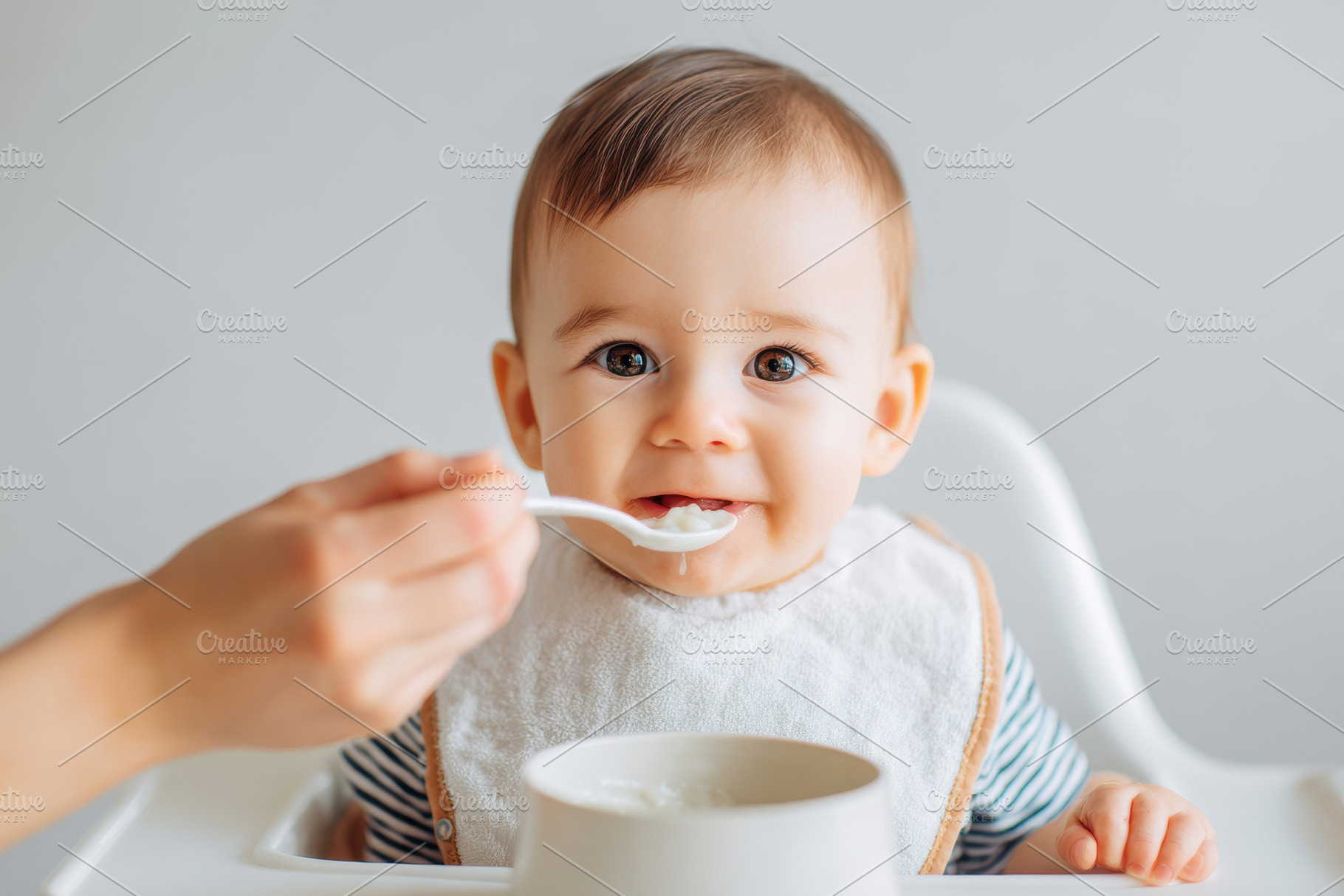 Happy baby enjoying mealtime in high chair, a Person Photo by AlyaAnd