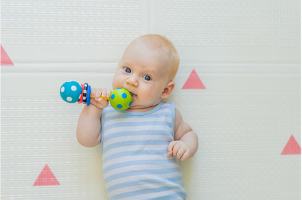 Adorable baby playing with colorful