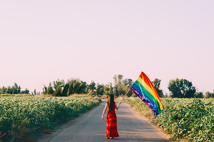 woman with lgbt flag on a country ro, a Person Photo by Fotoeventis