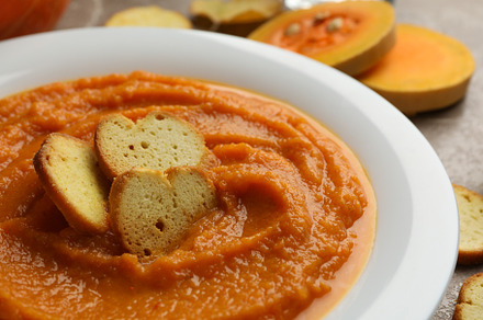 Plate of pumpkin puree with croutons on gray background, close u, a Food & Drink Photo by AtlasStudio PRO
