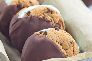 Mint chocolate chips ice cream and chocolate chips cookies sandwiches, vertical, a Food & Drink Photo by iuliia_n