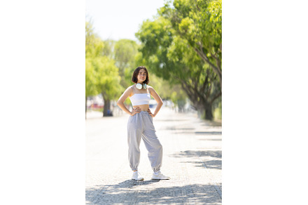A woman is standing on a sidewalk