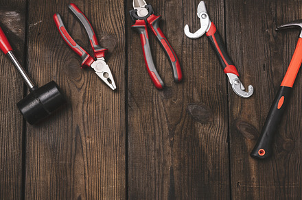 A set of construction tools on a brown wooden background, top vi, an Industrial Photo by ndanko