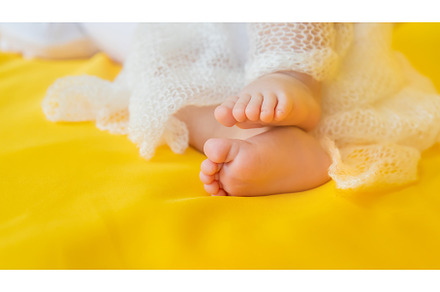 Baby feet on a yellow background, a Person Photo by yanadjana