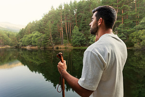Hiker contemplating a calm forest in, a Sports & Recreation Photo by Perpis