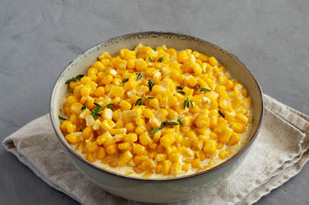 Homemade Slow Cooker Creamed Corn in a Bowl on a gray background, a Food & Drink Photo by LiudmylaChuhunova