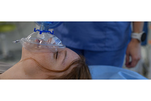 Medical staff applying oxygen mask, a Health & Medical Photo by HalfPoint