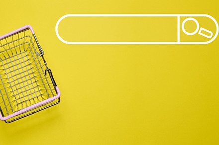 Empty miniature shopping cart on yellow background, top view, a Background Photo by ndanko