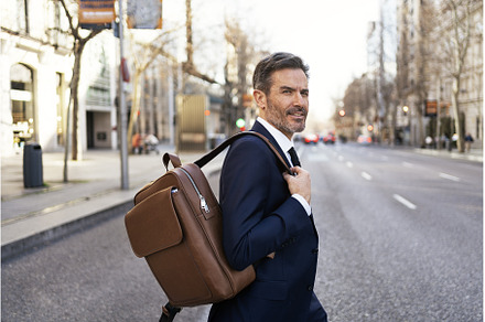 Confident businessman crossing road, a Person Photo by nunezimage