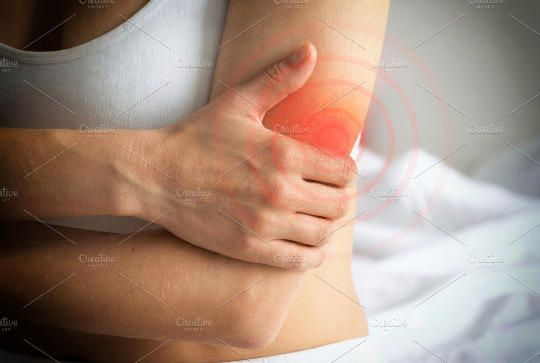 Woman Holding Painful Elbow with Red Highlight, a Health & Medical Photo by Davizro's Market