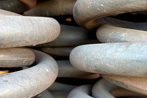 Close-up view of large metal springs stacked together, showcasing their coiled, an Industrial Photo by Textures & Backgrounds