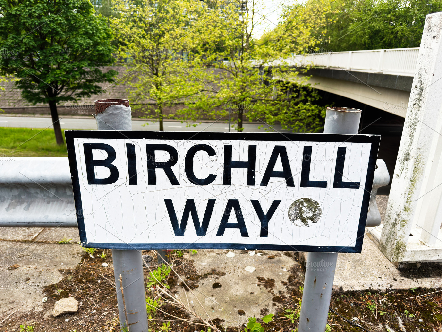Birchall Way street sign on a worn metal post near an overpass i, a Photo by AS photostudio