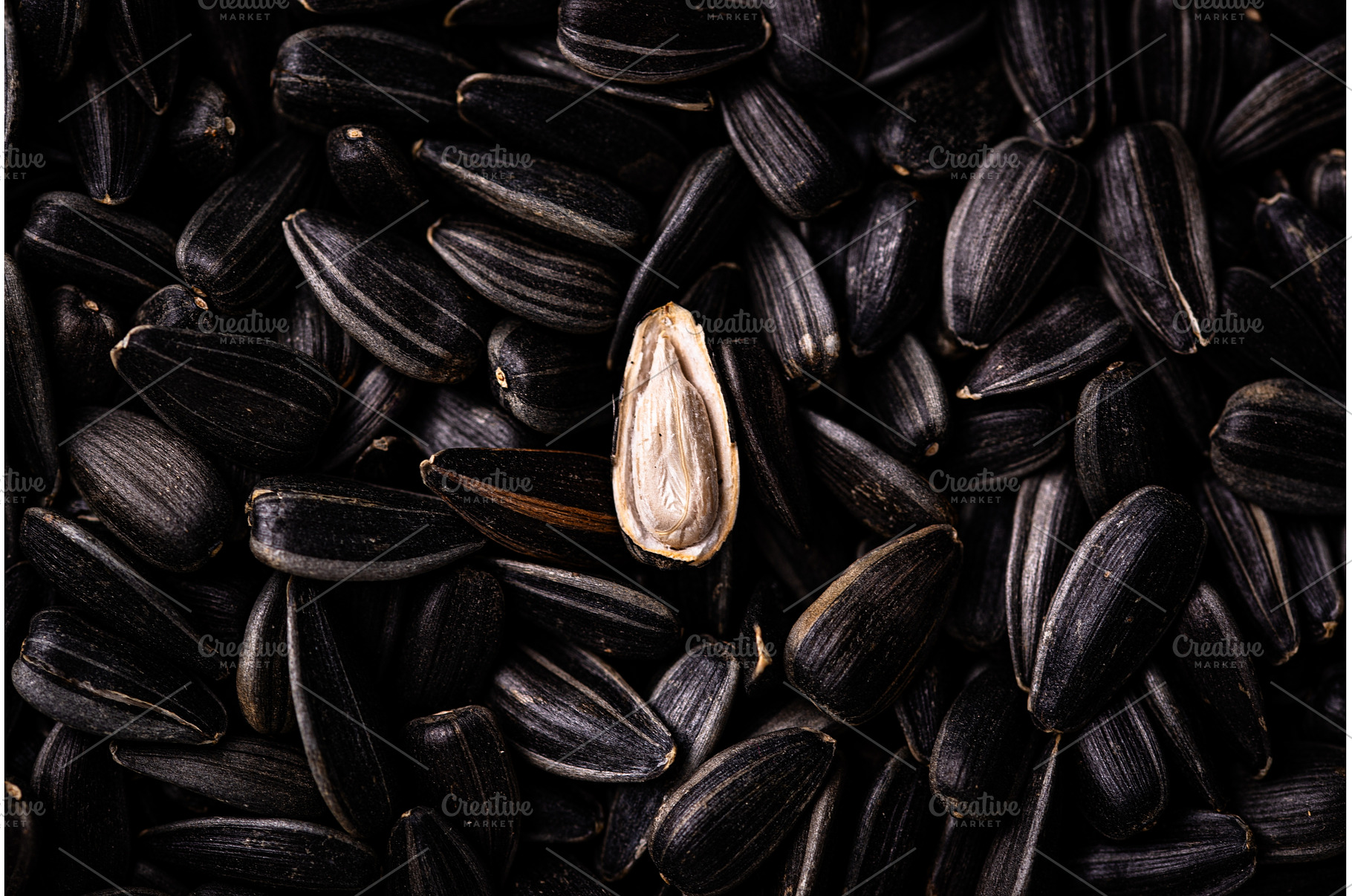 Sunflower seeds on black background, a Food & Drink Photo by Yulia Furman