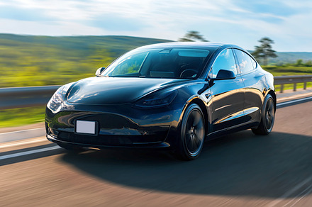 Front view of a moving black car on, a Transportation Photo by frimufilms