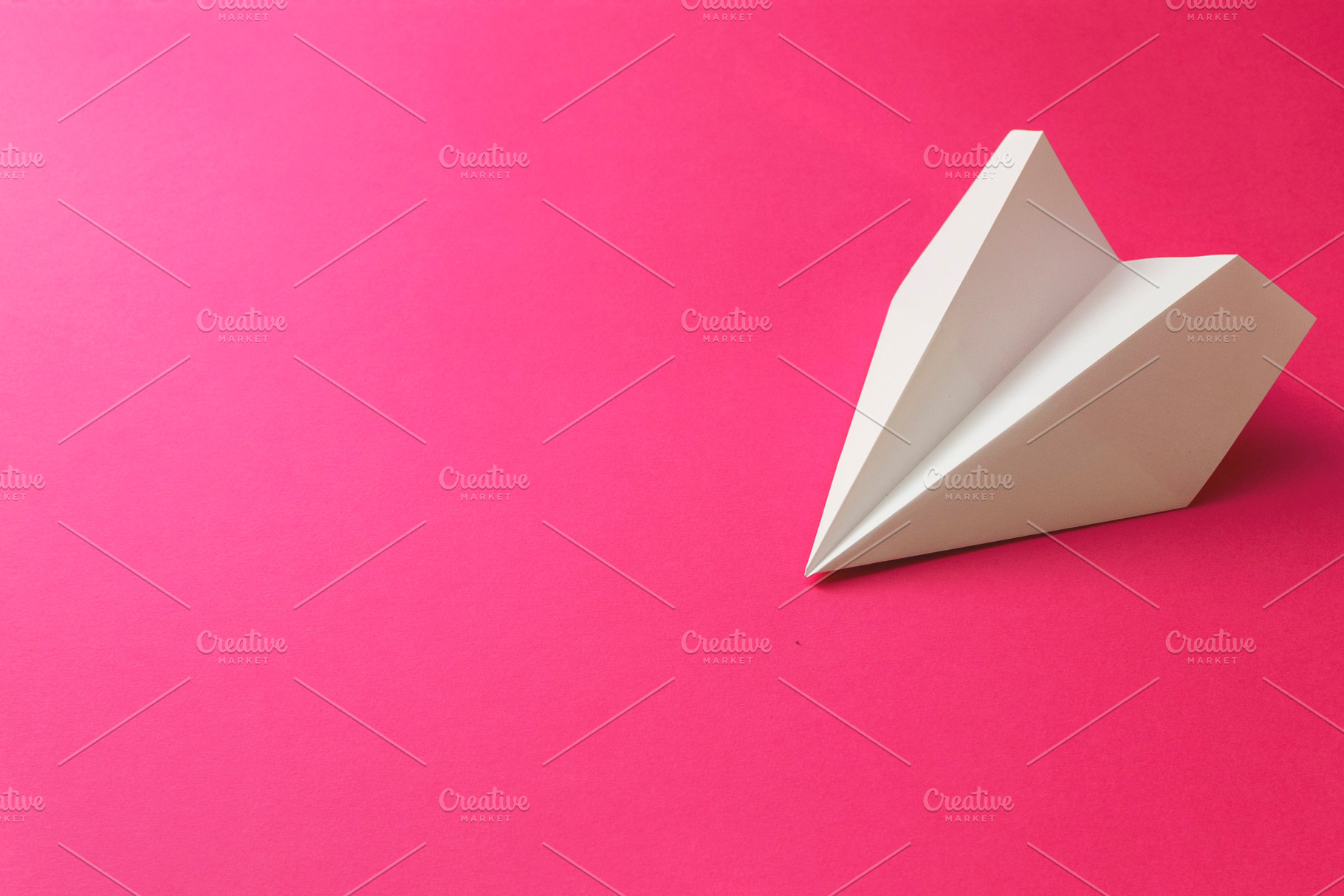 Paper plane on a pink background, a Transportation Photo by Ti-Di