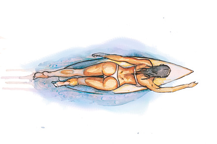 a girl swims on a surfbord