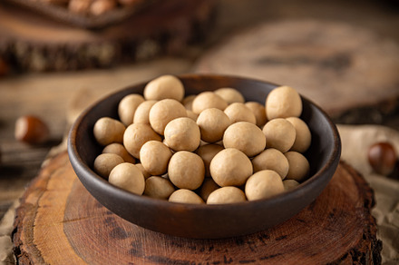 Crunchy roasted hazelnuts coated with white chocolate, a Photo by Grafvision photography
