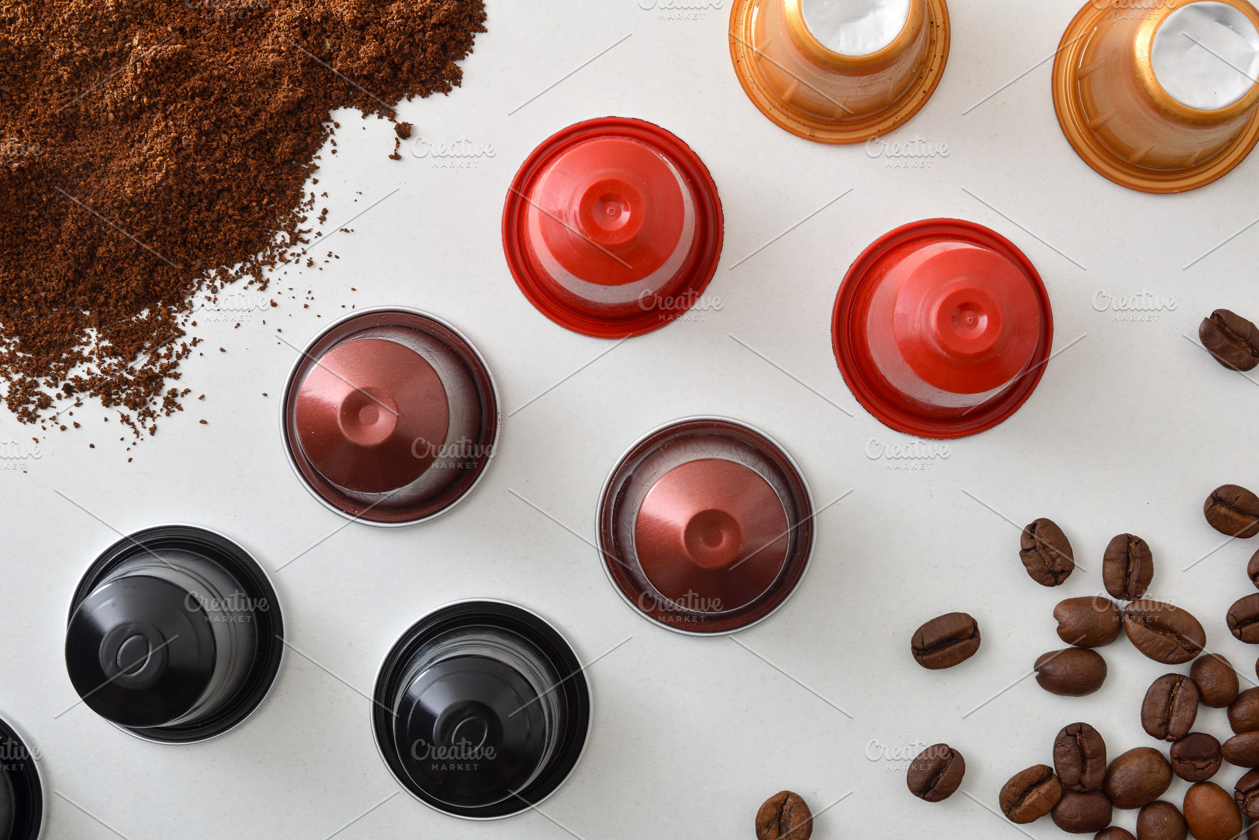 Multi-flavored espresso capsules with beans and ground coffee on, a Food & Drink Photo by Davizro's Market