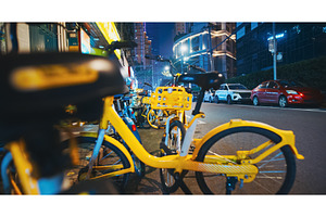 Bicycles and Cars Aligned Along a, a Transportation Photo by Our Amazing World