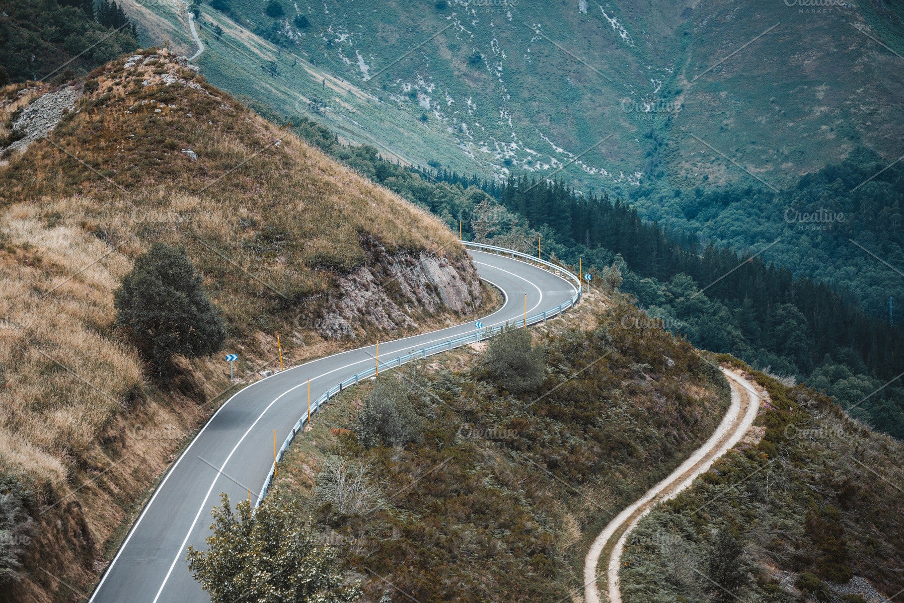 Curvy road in scenic mountain landscape, a Transportation Photo by SkyNext