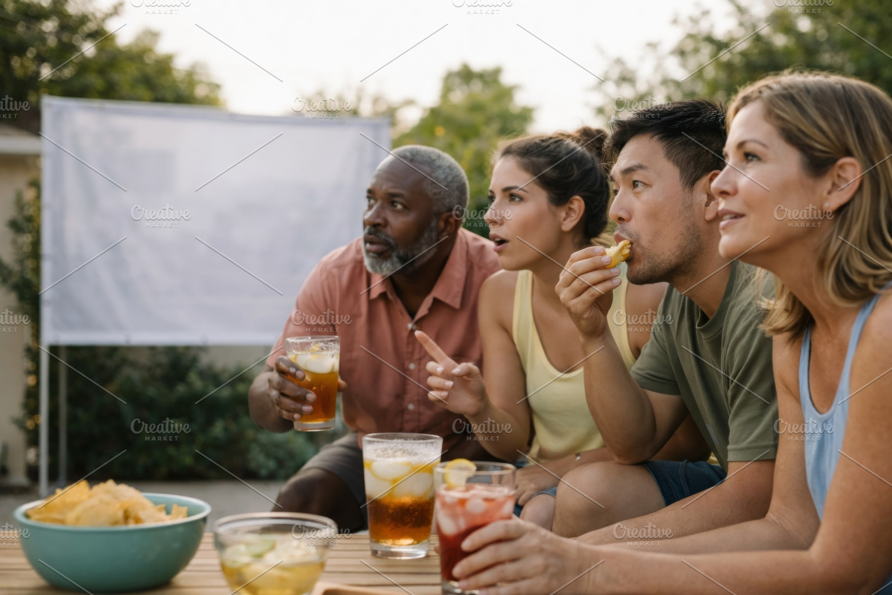 Sports fans watching a game outdoors, a Photo by Dvoevnore photos