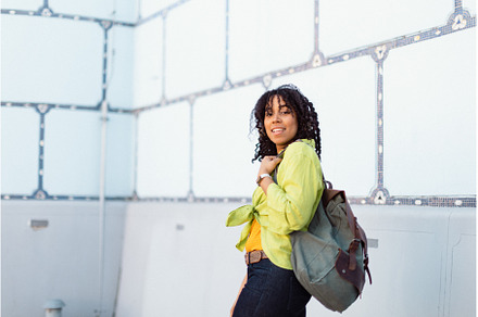 Young biracial woman with backpack, a Person Photo by HalfPoint