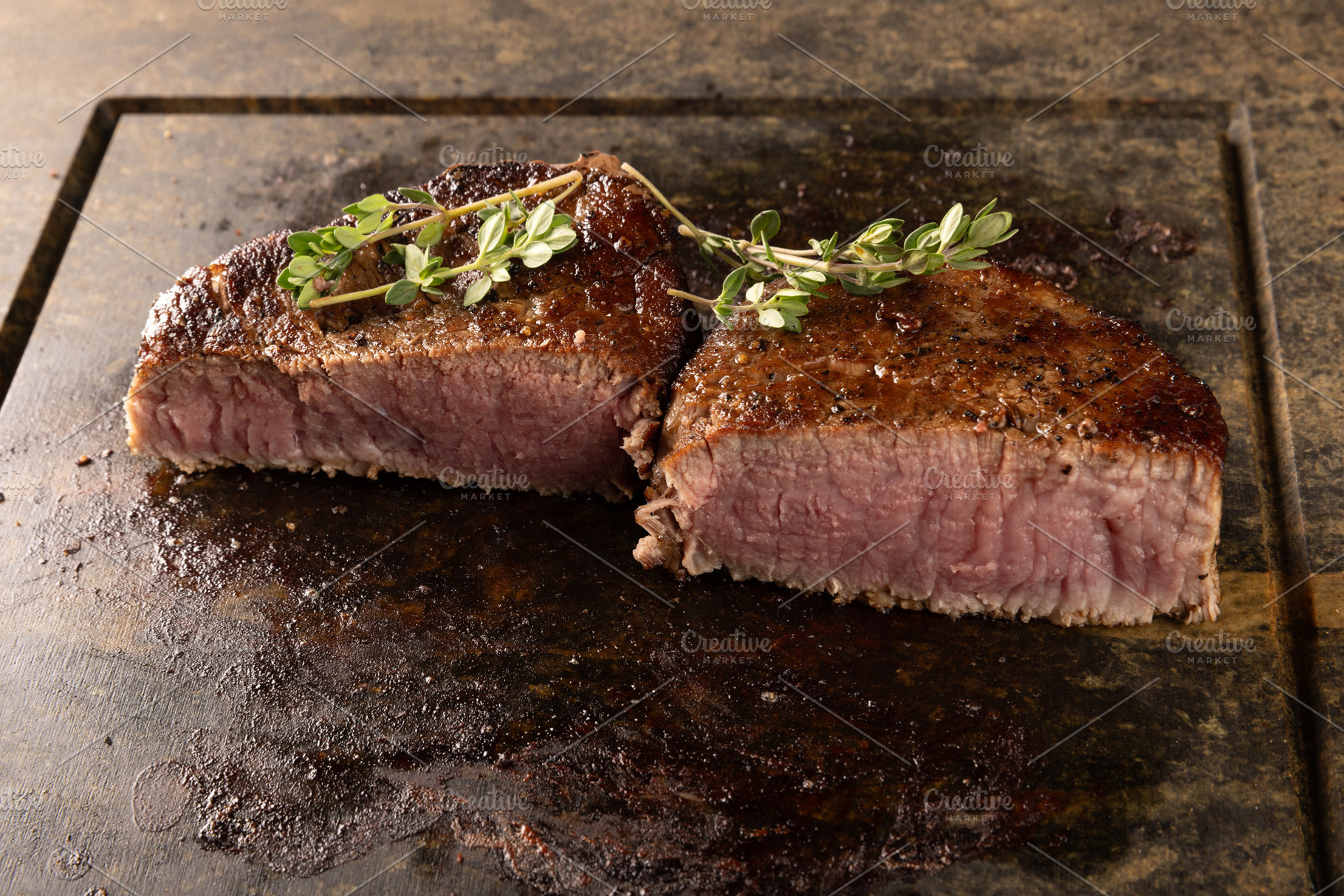 Sizzling medium rare filet mignon steaks, a Photo by Grafvision photography