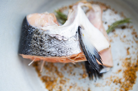 A chopped piece of salmon steak is on a plate along with spices and rosemary. C, a Food & Drink Photo by Artsaba Family
