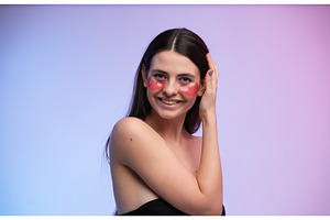 Young woman smiling while applying, a Health & Medical Photo by volodymyrshtun13795
