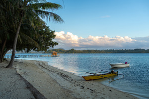 Sunset beach with boats at Bolilanga Island, Togian archipelago,, a Nature Photo by GoodGoods