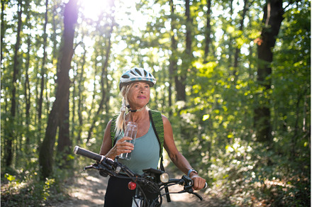 Happy senior woman biker drinking, a Sports & Recreation Photo by HalfPoint