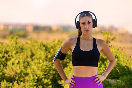 Young woman wearing headphones after, a Sports & Recreation Photo by Perpis