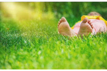 The child lies on the grass, a Person Photo by yanadjana