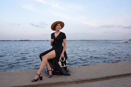 Elegant woman in summer dress gazes
