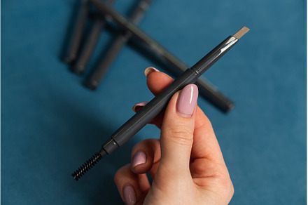 Woman holding mascara for eyelashes