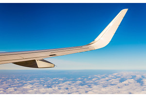 Aircraft wing flying over clouds, a Transportation Photo by Leonid Andronov