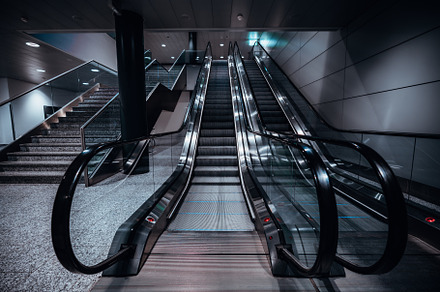 Two escalators indoors, wide angle, an Industrial Photo by SkyNext