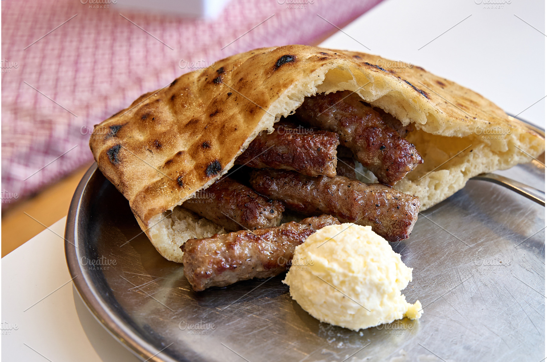 Sarajevo-style cevapi aka Sarajevski, a Food & Drink Photo by Oleksandr Berezko