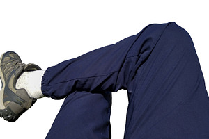 Legs with jogging and sneakers resting isolated photo, a Photo by DanFLCreativo
