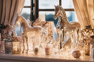 Silver horse figurines and decorative objects creating an elegan, a Photo by Studio ANNA