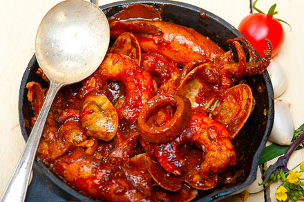 fresh seafoos stew on an iron skillet, a Food & Drink Photo by keko64