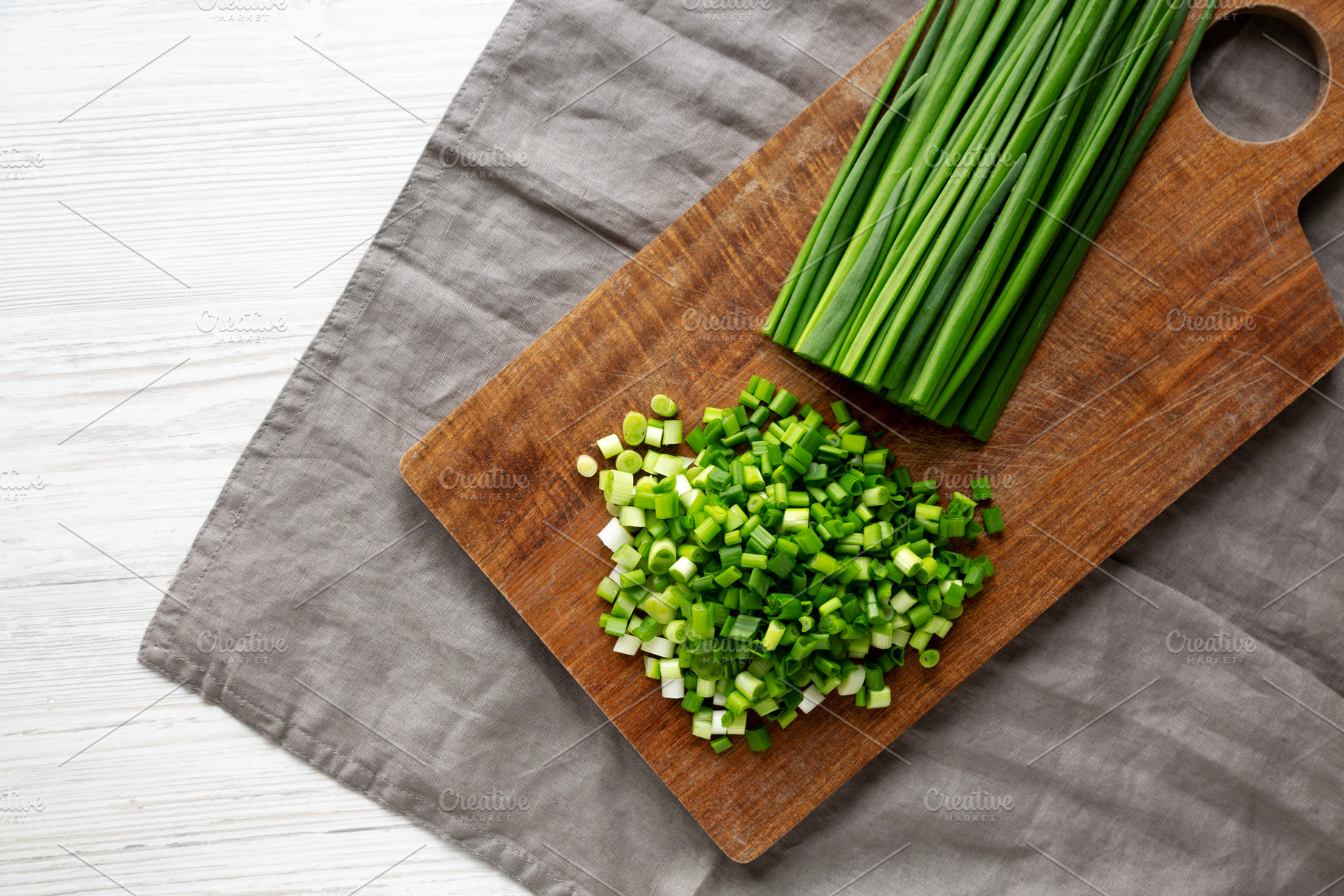 Organic Cut Green Onion Scallions on a Wooden Board, top view., a Food & Drink Photo by LiudmylaChuhunova